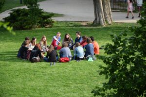 Group of people sitting on grass